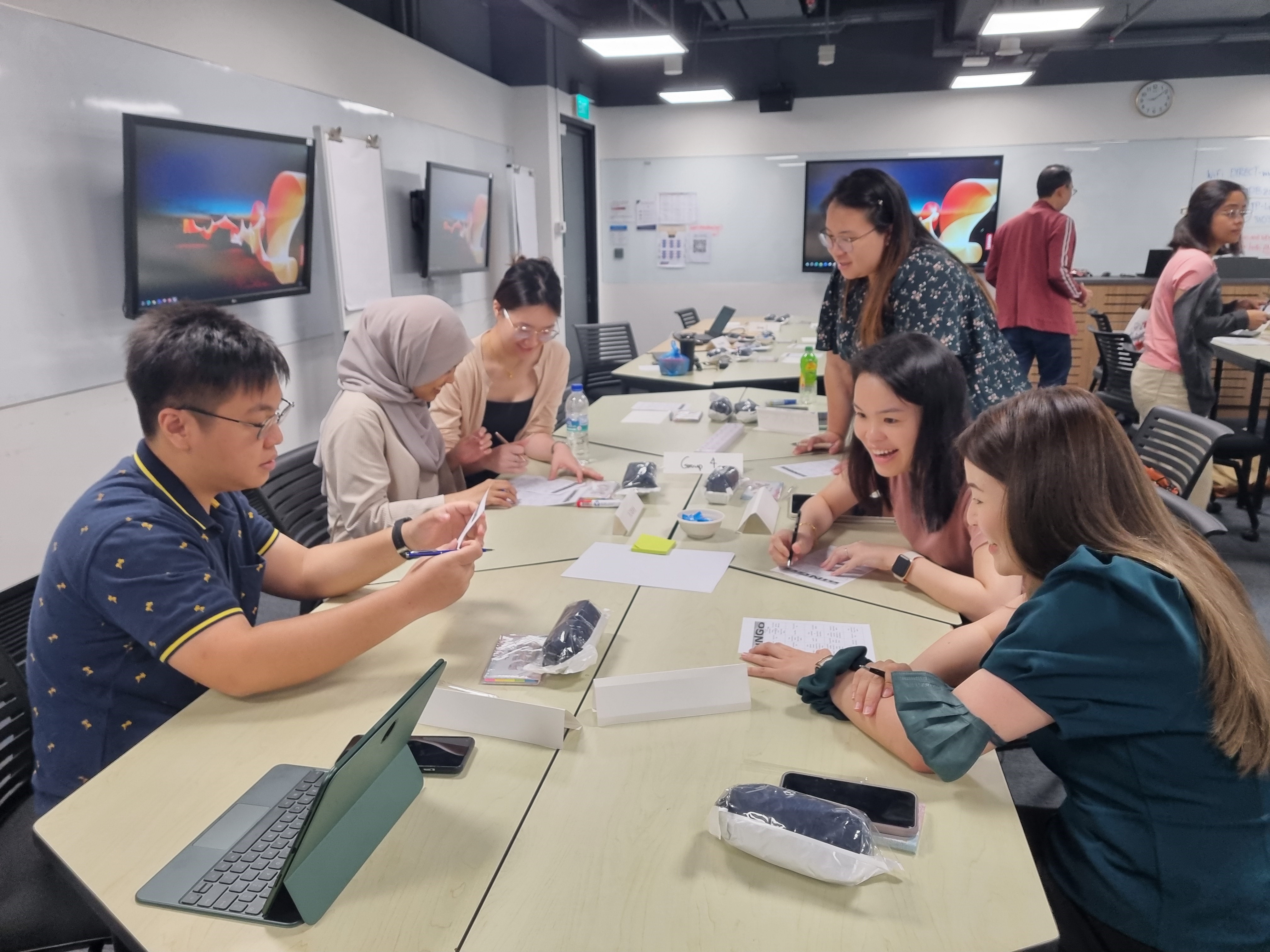 Participants engaging in group discussions and hands-on activities such as role-playing.